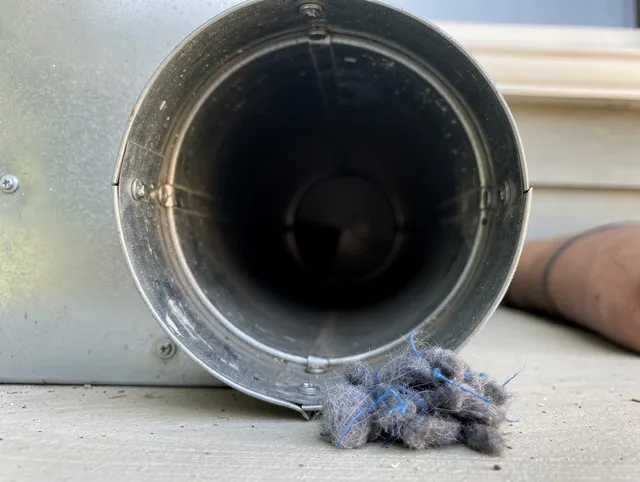 Lewisboro Dryer Vent Cleaning technician using specialized equipment to clear severe dryer vent blockage in Lewisboro